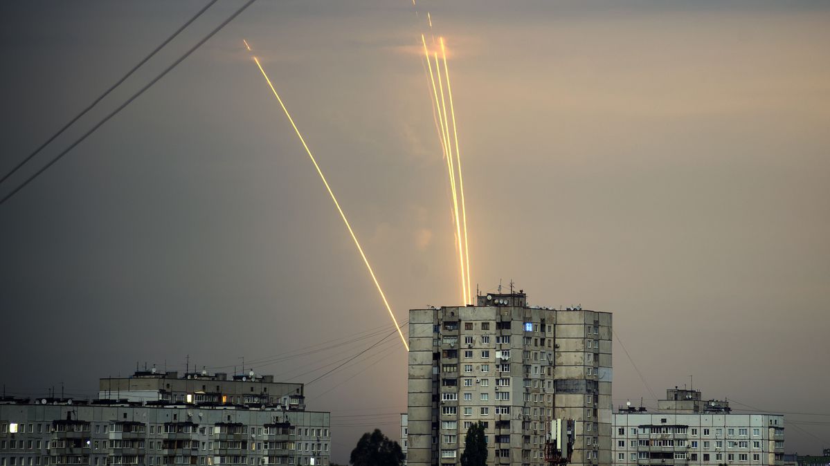 Rockets are being fired at Kharkiv from Russia’s Belgorod region. Two rockets cross the sky behind old apartment blocks.