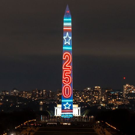 The Washington Monument in Washington DC is illuminated in red white and blue to celebrate America 250.