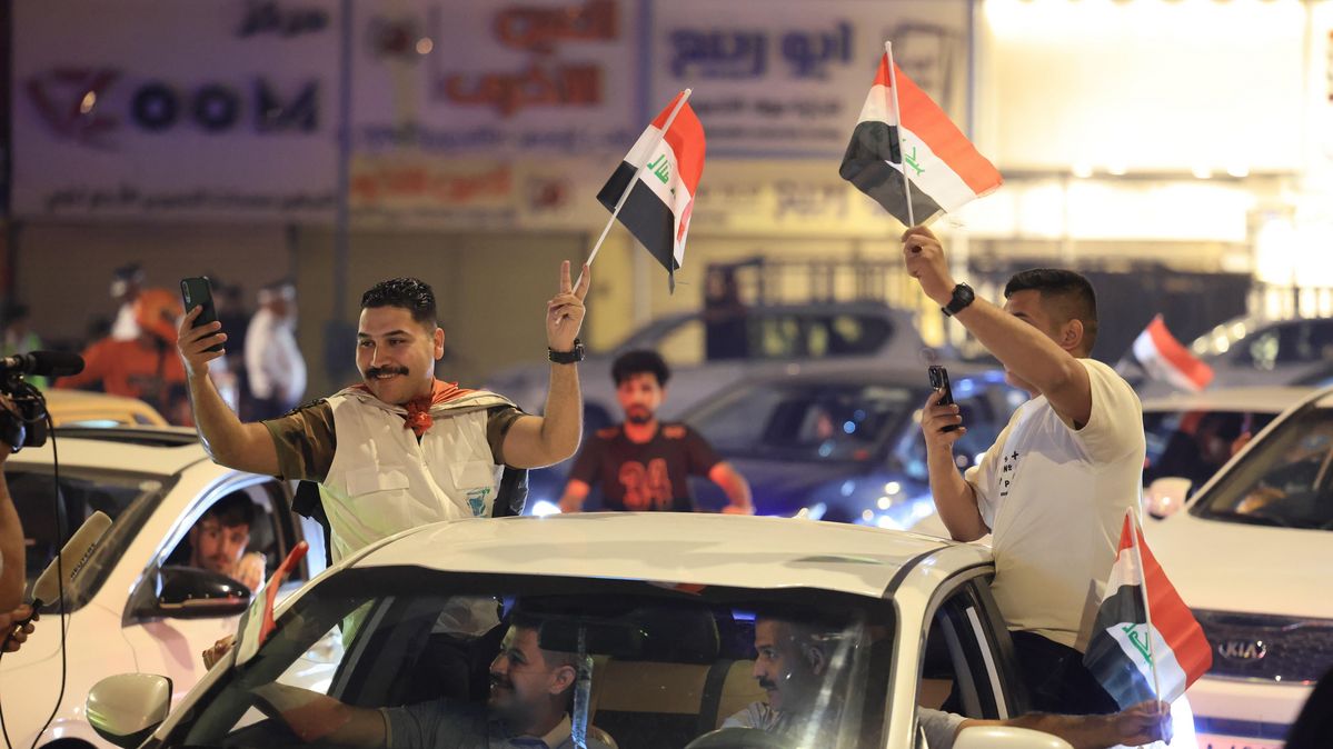 Supporters of Iraqi prime minister Mohammed Shia al-Sudani celebrate on the street after his Reconstruction and Development Coalition had won the elections. People celebrating on the streets in a car