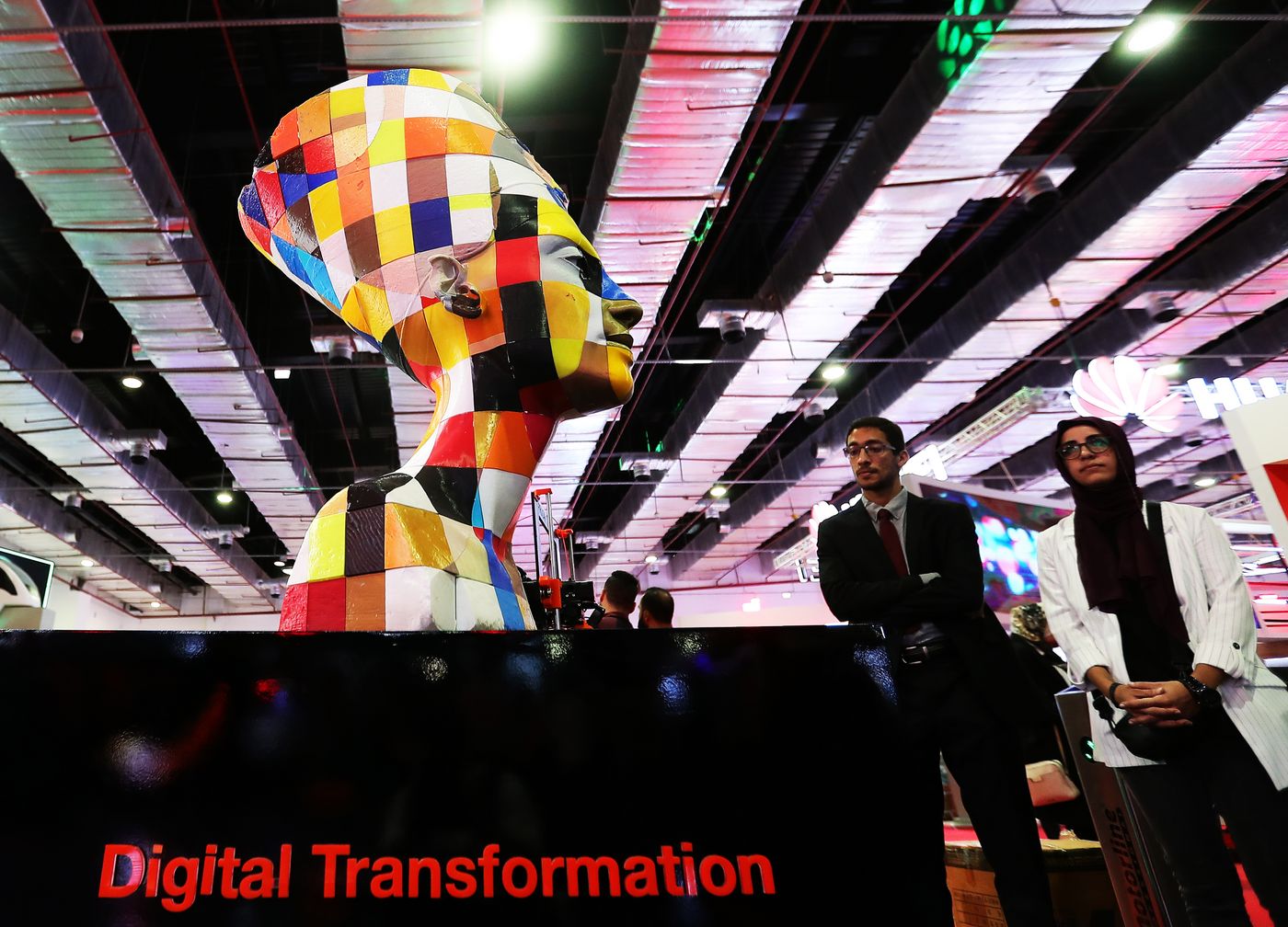 Cairo, 7 November 2021: Visitors walk past a multi-coloured replica of the statue of Nefertiti to explore the Smart Transportation and Logistics Fair and Forum for the Middle East and Africa (TransMEA 2021).